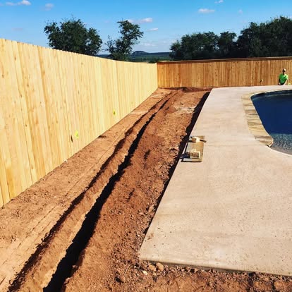 Fresh irrigation trench beside a pool deck