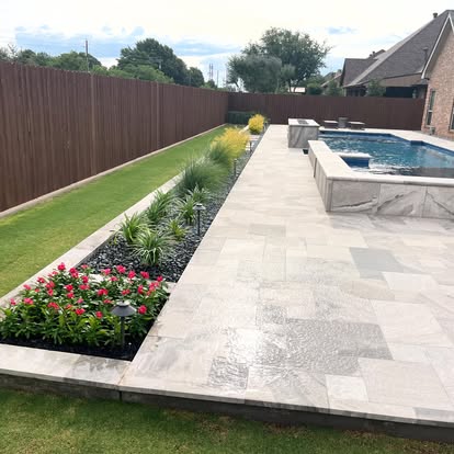 Finished poolside planting, lawn, and stone patio by First Choice Lawn and Landscape in the Abilene area