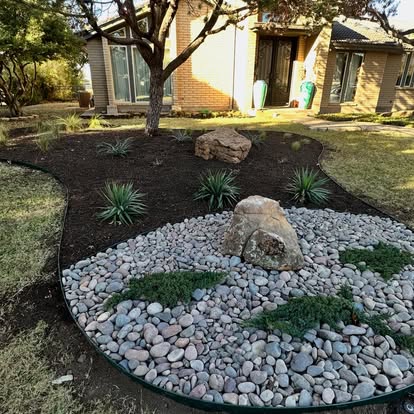 Finished rock, mulch, and drought-conscious planting bed by First Choice Lawn and Landscape in the Abilene area